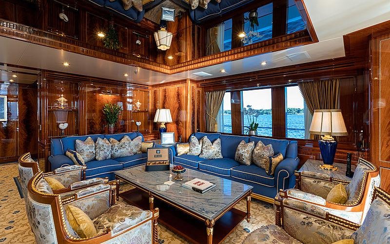 a living room with a large window aboard KADIMO'S Yacht for Charter