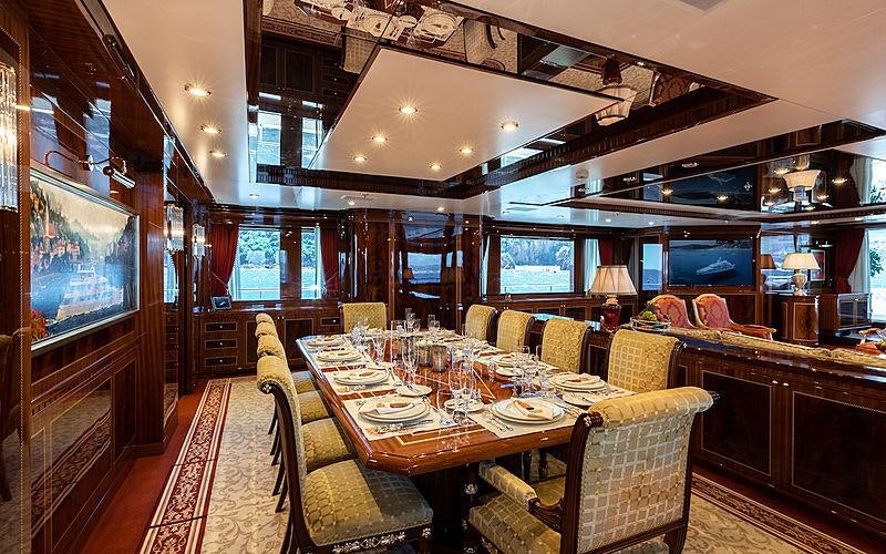 a dining room with a large table aboard KADIMO'S Yacht for Charter