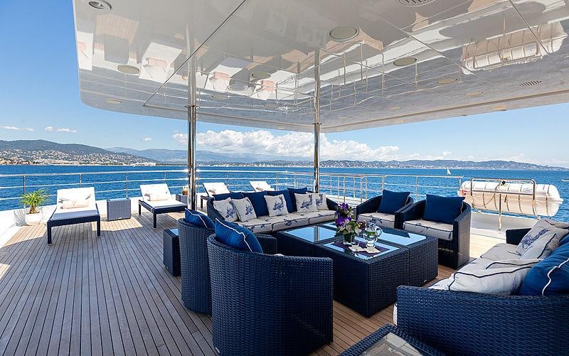 a large patio with a table and chairs aboard KADIMO'S Yacht for Charter