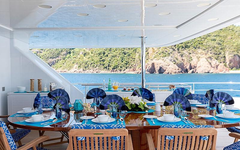 a room with a table and chairs aboard KADIMO'S Yacht for Charter