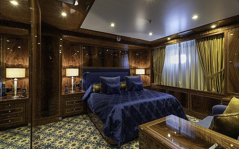 a large bedroom with a large bed aboard KADIMO'S Yacht for Charter
