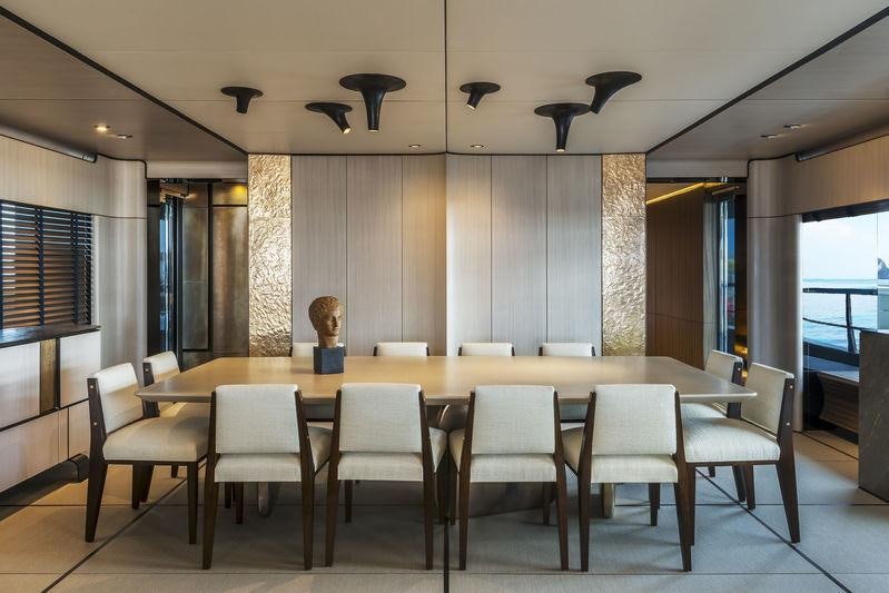 a table with chairs around it aboard ENDEAVOUR 2 Yacht for Charter