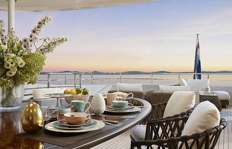 a table with a plate and chairs on it aboard ARKADIA Yacht for Charter