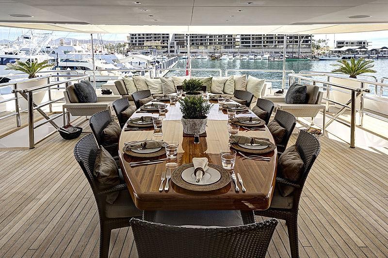 a room with tables and chairs aboard AZTECA Yacht for Charter