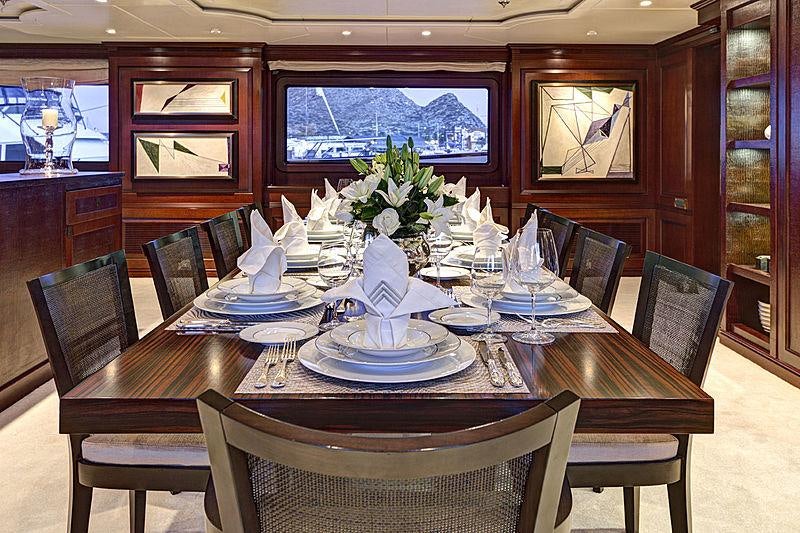 a dining table set with dinnerware aboard AZTECA Yacht for Charter
