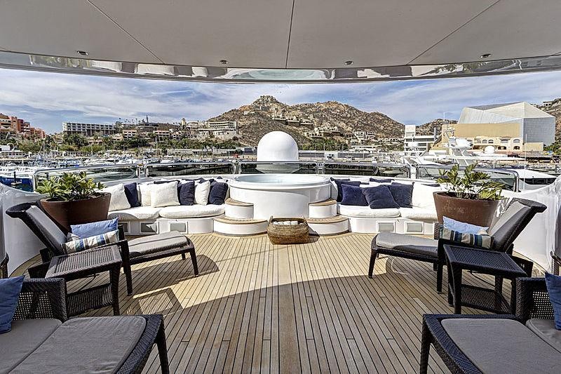 a patio with a large white building and a large body of water aboard AZTECA Yacht for Charter