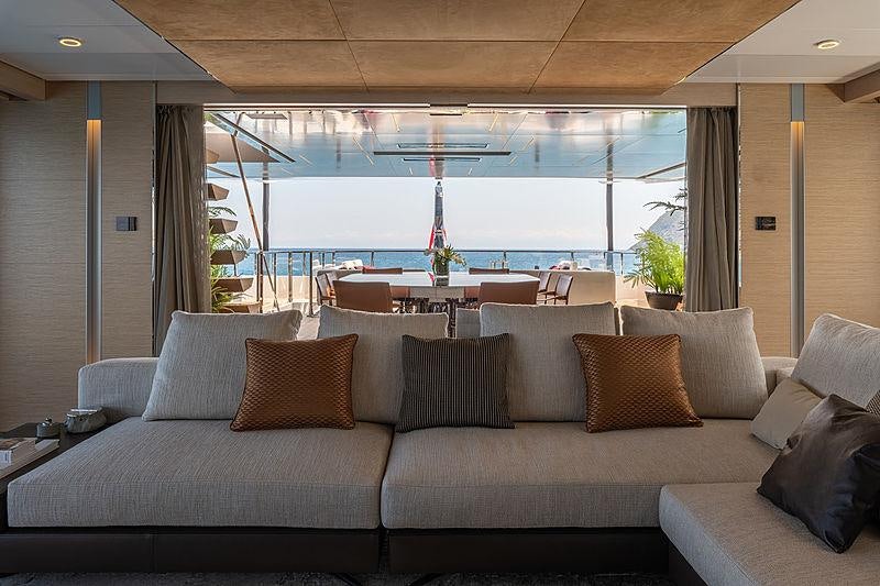 a couch with pillows and a view of the ocean aboard LEL Yacht for Charter