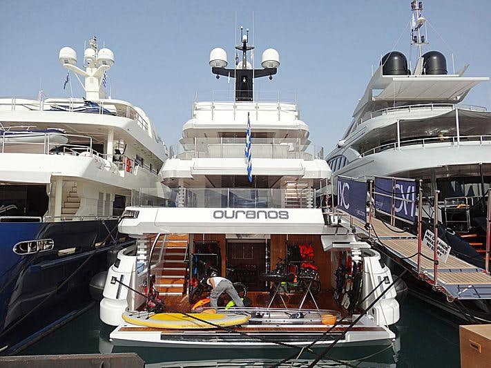 a large boat docked at a port aboard OURANOS Yacht for Charter