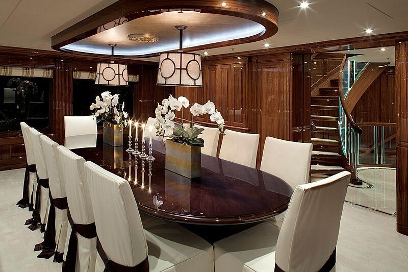 a dining room with a set of chairs and a staircase aboard REMEMBER WHEN Yacht for Charter