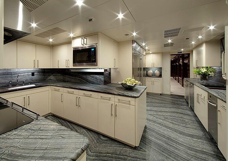 a large kitchen with white cabinets aboard REMEMBER WHEN Yacht for Charter