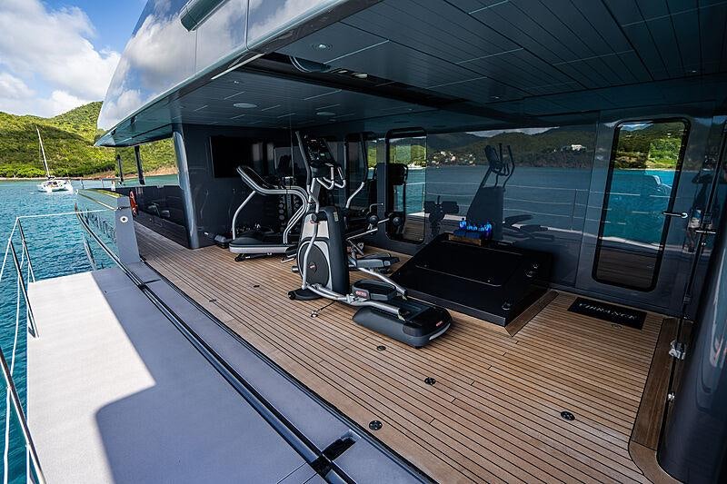 a deck with a deck and a pool aboard VIBRANCE Yacht for Charter