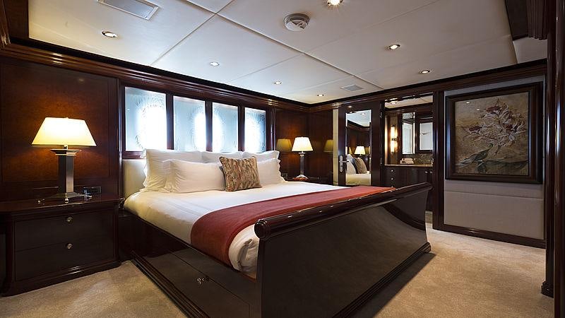 a large bed in a hotel room aboard LA DEA II Yacht for Charter