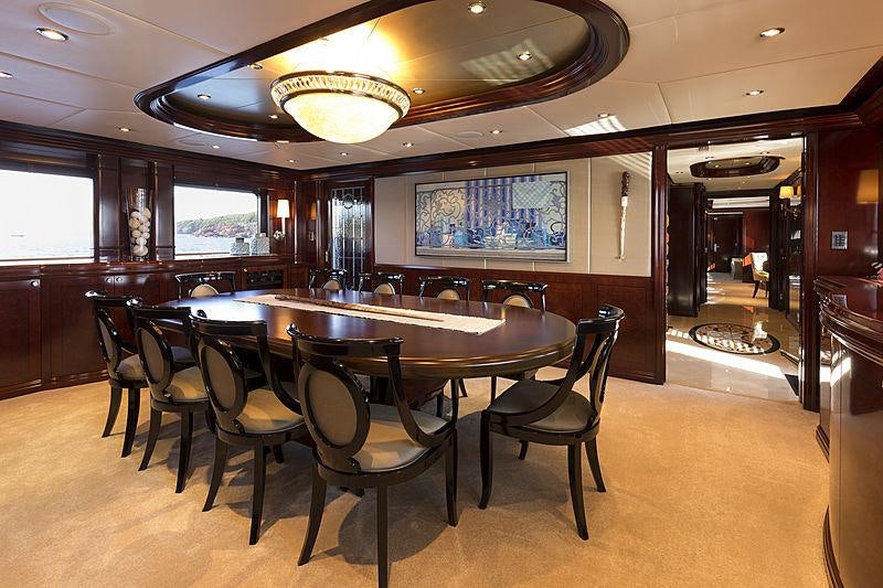 a large table with chairs around it aboard LA DEA II Yacht for Charter