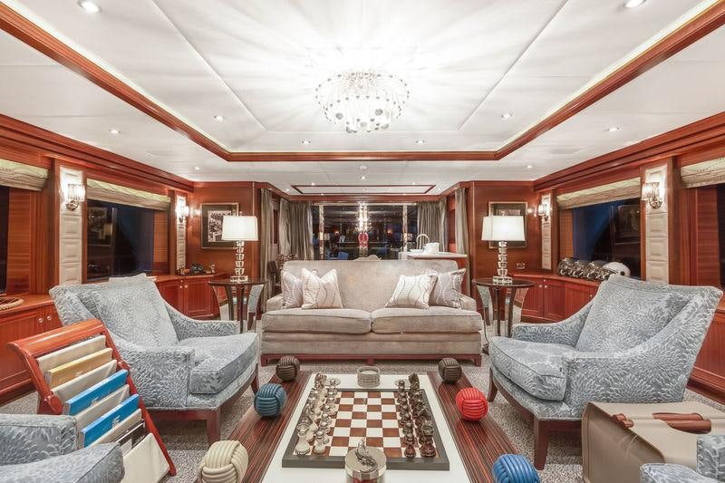a living room with a large mirror aboard OCEAN CLUB Yacht for Charter
