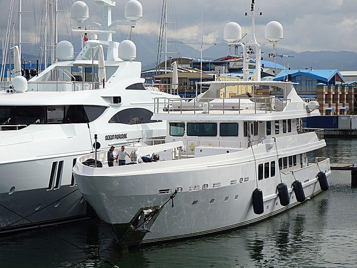 a couple of boats are parked in a harbor aboard R23 Yacht for Charter
