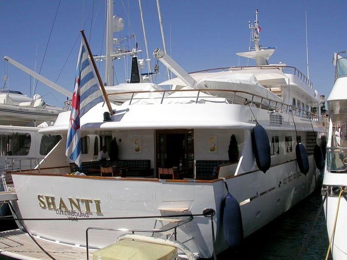 a white yacht with a flag on the front aboard SHAKE N' BAKE TBD Yacht for Charter
