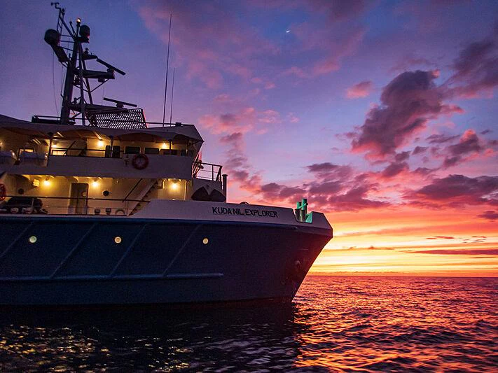 a large ship in the water aboard KUDANIL EXPLORER Yacht for Charter