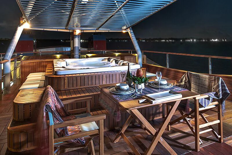 a table with chairs around it aboard KUDANIL EXPLORER Yacht for Charter