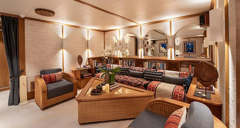 a living room with a leather couch and a coffee table aboard KUDANIL EXPLORER Yacht for Charter