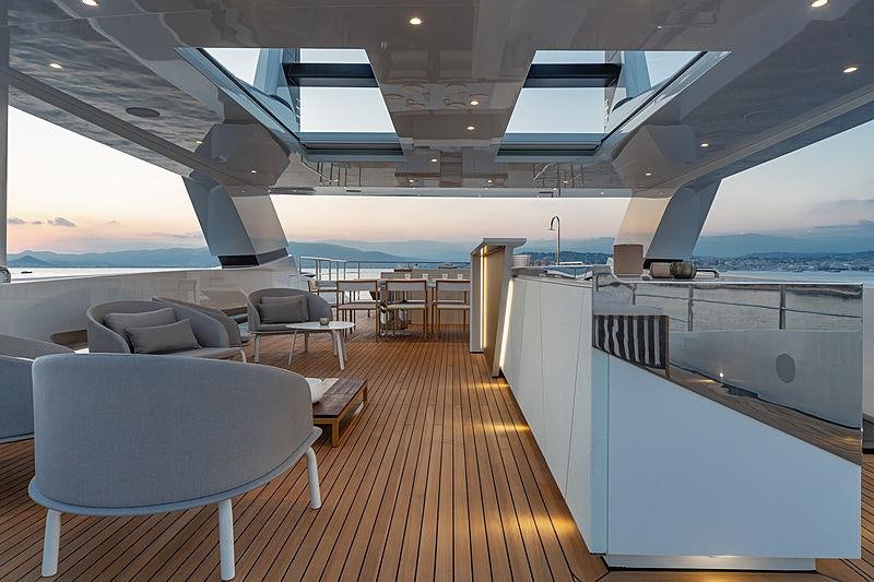 a large room with a wood floor and a large window aboard MY MAYVA Yacht for Charter