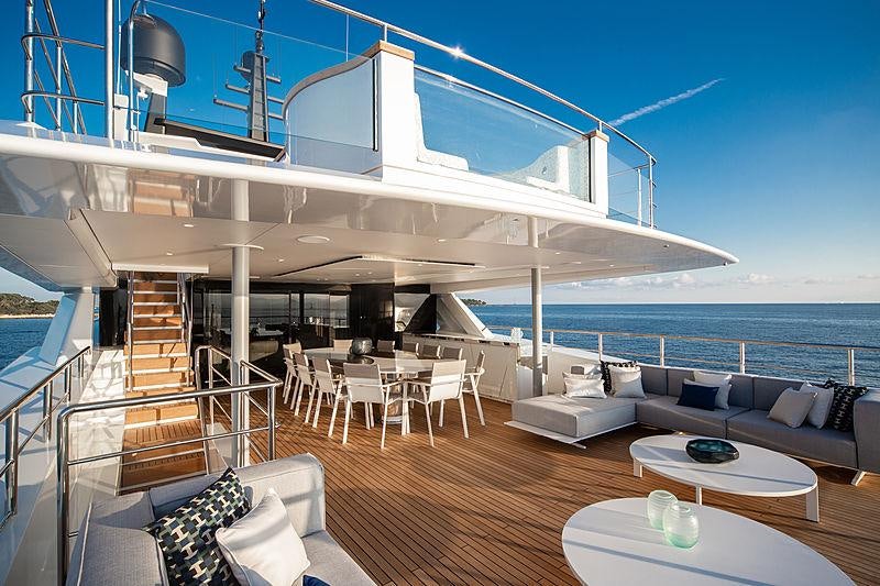 a large living room with a large balcony overlooking the ocean aboard MY MAYVA Yacht for Charter