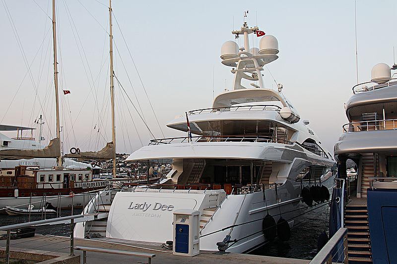 a large white boat sits in a dock aboard LADY DEE Yacht for Charter
