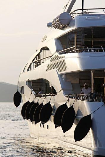 a large white boat with black tires aboard LADY DEE Yacht for Charter