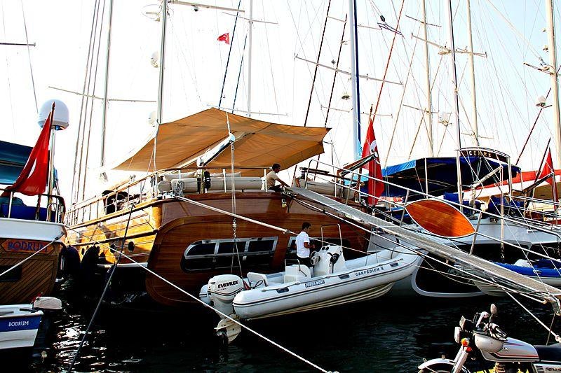 a boat docked with a boat aboard LA BELLA VITA Yacht for Charter