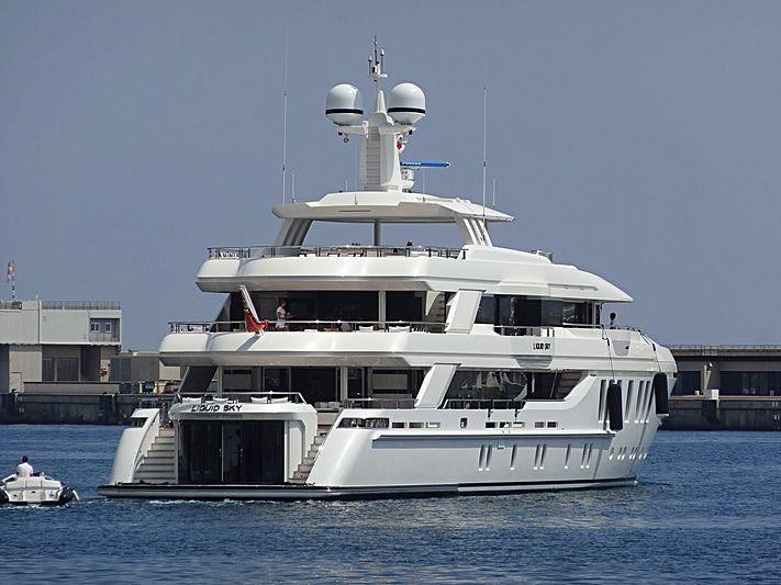 a large white boat in the water aboard LIQUID SKY Yacht for Charter