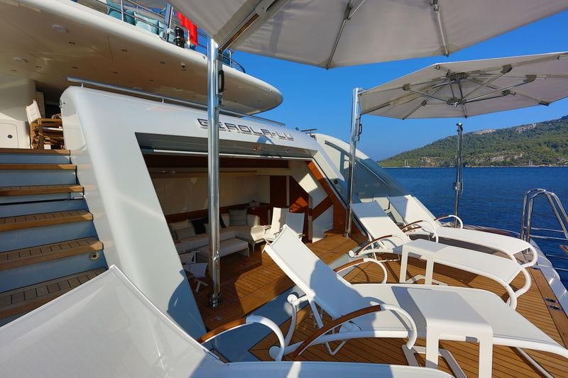 a boat with white chairs on the deck aboard QUASAR Yacht for Charter