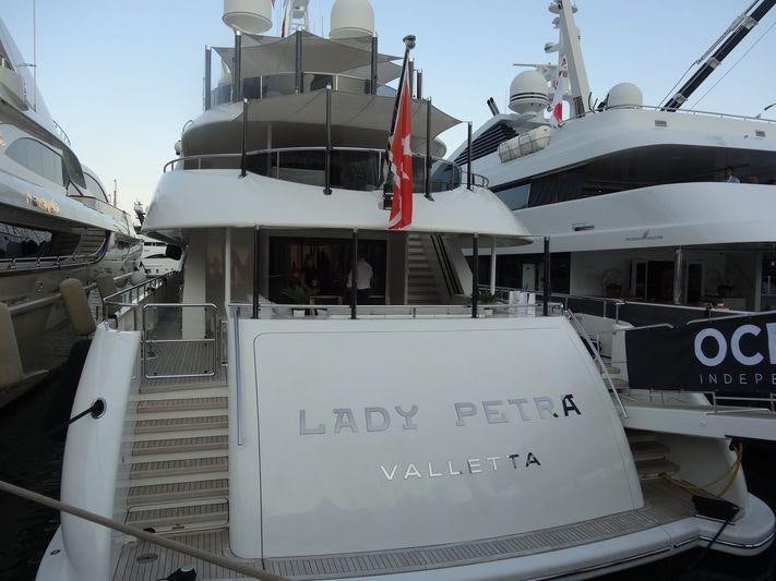 a boat with a flag on the front aboard ODYSSEA Yacht for Charter