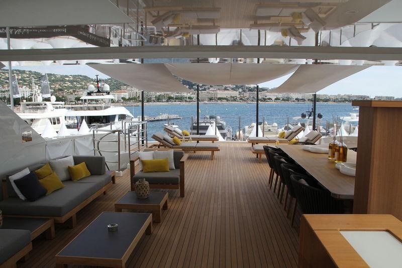 a room with a couch and a table and chairs aboard MR. T Yacht for Charter