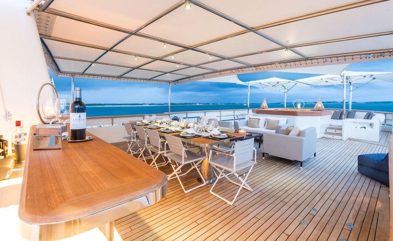 a room with a table and chairs aboard PIONEER Yacht for Charter