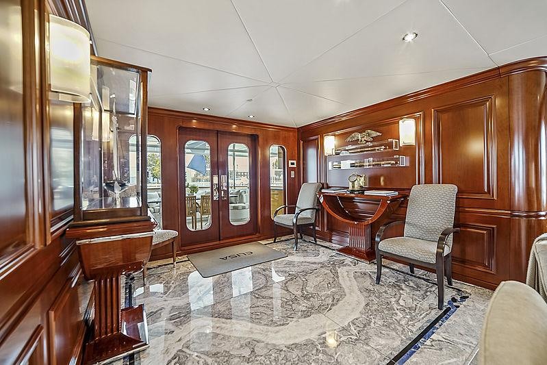 a large room with wooden cabinets aboard ARTEMIS Yacht for Charter