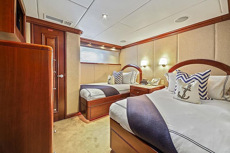 a bedroom with a bed and a closet aboard ARTEMIS Yacht for Charter