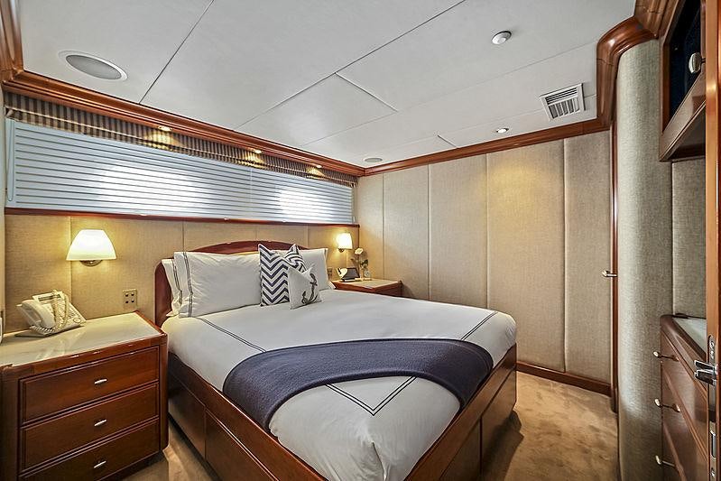 a bedroom with a bed and a desk aboard ARTEMIS Yacht for Charter