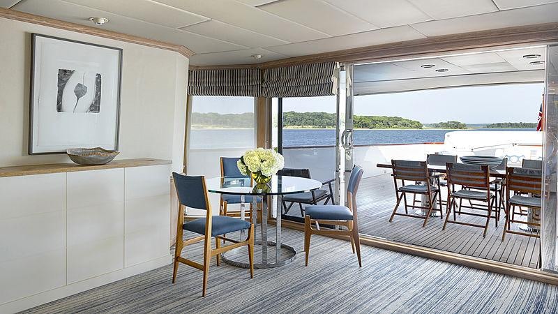 a room with a table chairs and a window aboard GOLDEN EAGLE Yacht for Charter