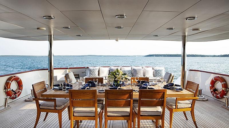 a table with chairs on it aboard GOLDEN EAGLE Yacht for Charter