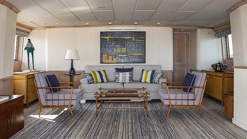 a living room with a couch and a table aboard GOLDEN EAGLE Yacht for Charter