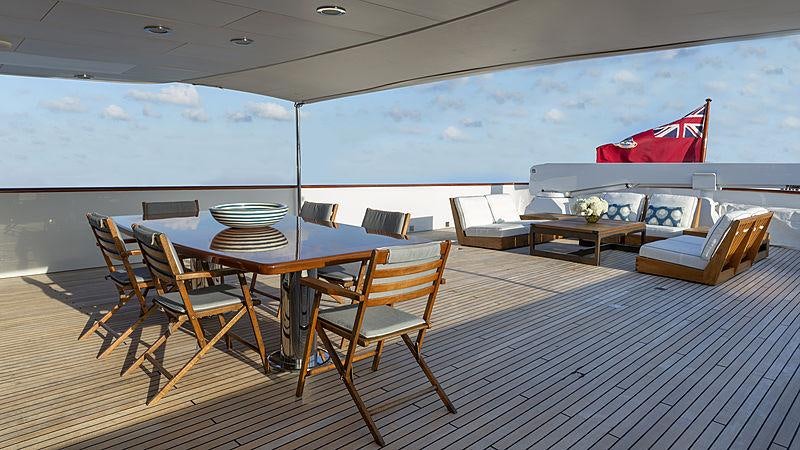 a room with a table chairs and a large window aboard GOLDEN EAGLE Yacht for Charter