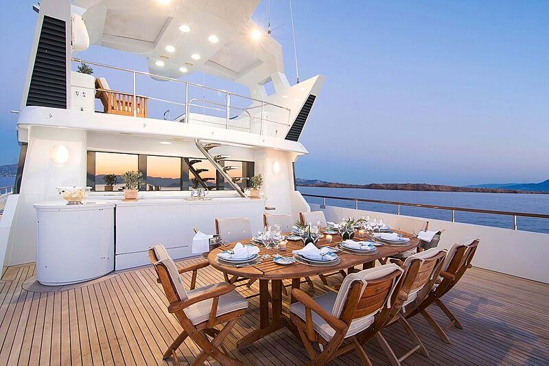 a table and chairs on a deck aboard BELLA STELLA Yacht for Charter
