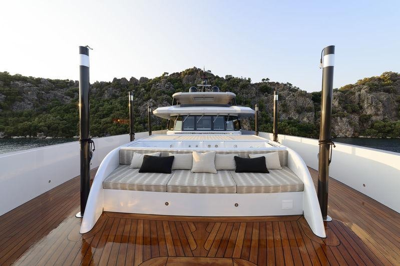 a white boat on a wooden dock aboard AQUARIUS Yacht for Charter