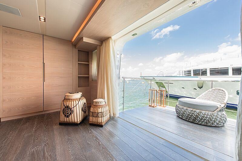a wood deck with a large window and a view of the ocean aboard FAST & FURIOUS Yacht for Charter