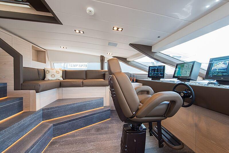 a room with a couch and a chair aboard FAST & FURIOUS Yacht for Charter