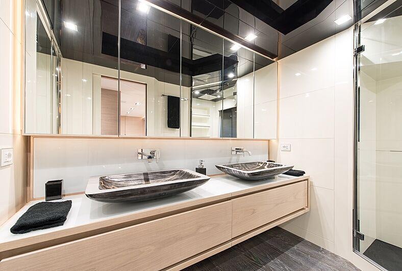a bathroom with a sink and a mirror aboard FAST & FURIOUS Yacht for Charter