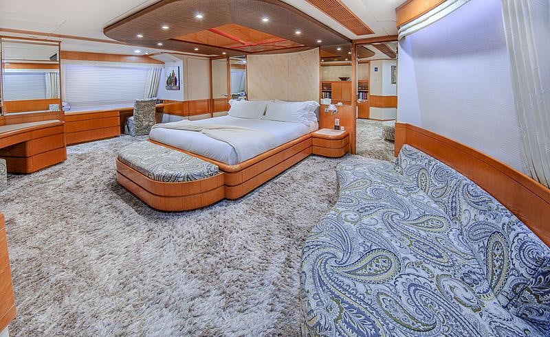 a large room with a bed and a desk aboard ISLAND HEIRESS Yacht for Charter