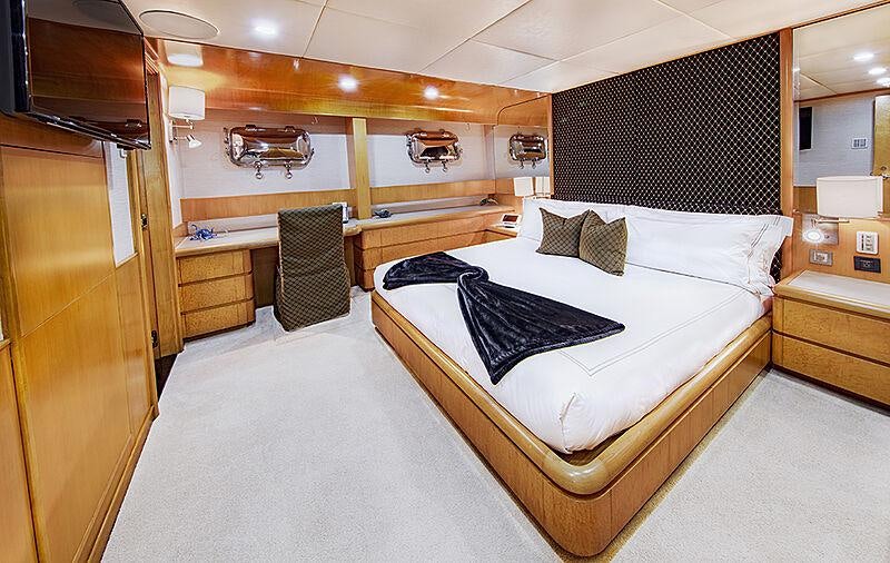 a room with a bed and a chair aboard ISLAND HEIRESS Yacht for Charter