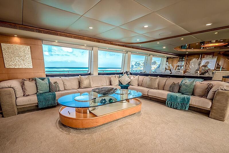 a living room with a large window aboard ISLAND HEIRESS Yacht for Charter
