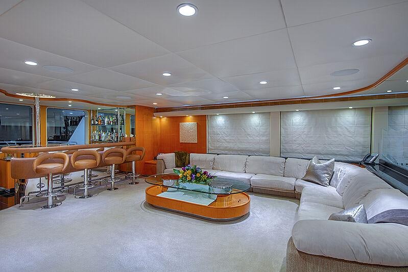 a living room with a large sofa and a coffee table aboard ISLAND HEIRESS Yacht for Charter