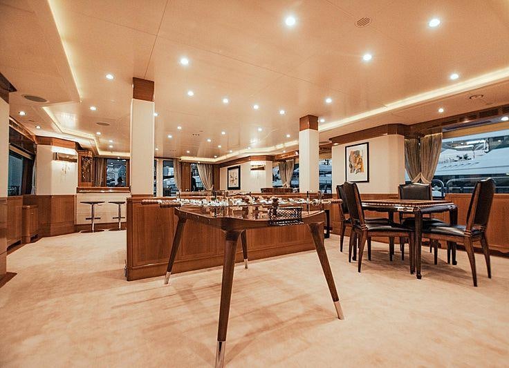 a large room with a table and chairs aboard ALEGRIA Yacht for Charter